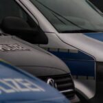 a row of police vans parked next to each other