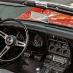 the dashboard of a red and black sports car