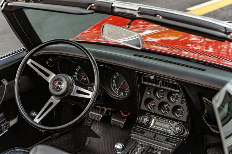 the dashboard of a red and black sports car
