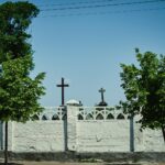 a white fence with a cross on top of it
