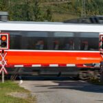 a red and white train traveling down train tracks
