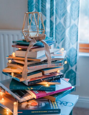 brown wooden framed candle holder on top of books