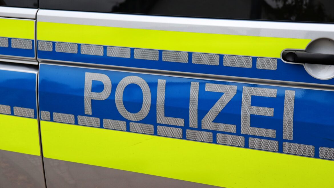 a blue and yellow police car parked on the side of the road