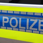 a blue and yellow police car parked on the side of the road