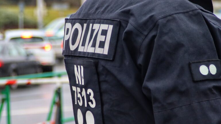 a police officer standing in front of a line of cars