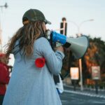 a woman drinking from a bottle